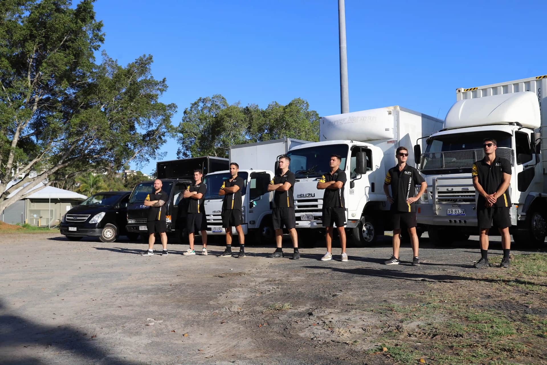 The Oz Wide Movers crew with their fleet of moving trucks