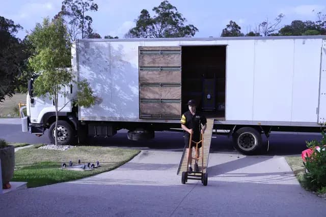 Removalists standing in front of trucks
