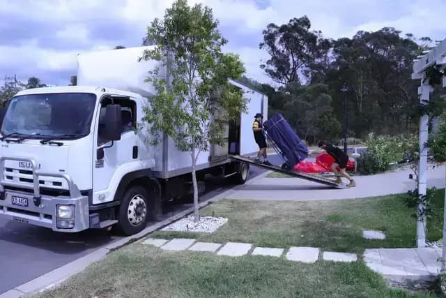 Removalists standing in front of trucks