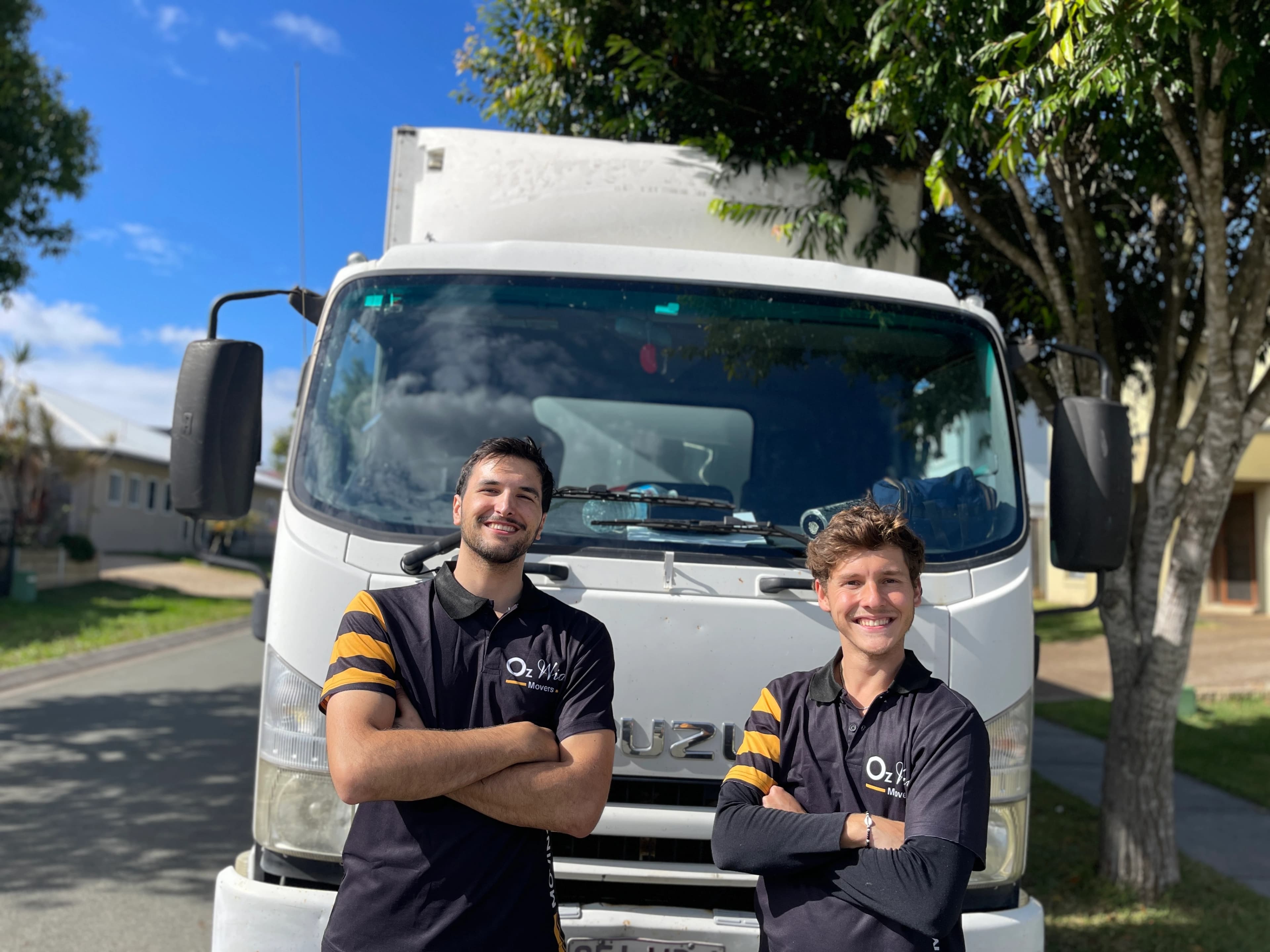 Removalists standing in front of trucks