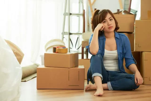 Professional movers loading boxes into a moving truck during peak season