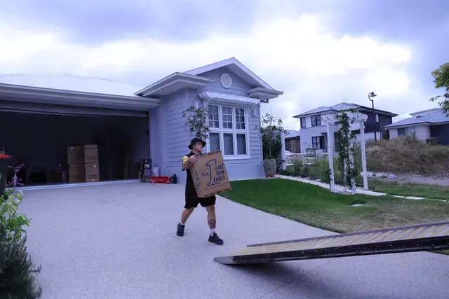 Removalists standing in front of trucks