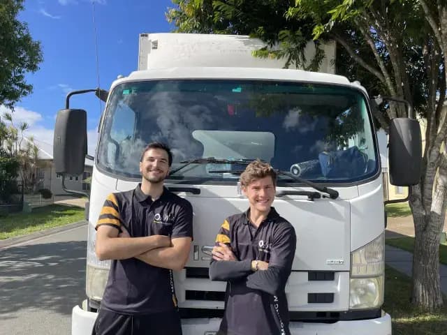 Office movers dismantling furniture in a meeting room
