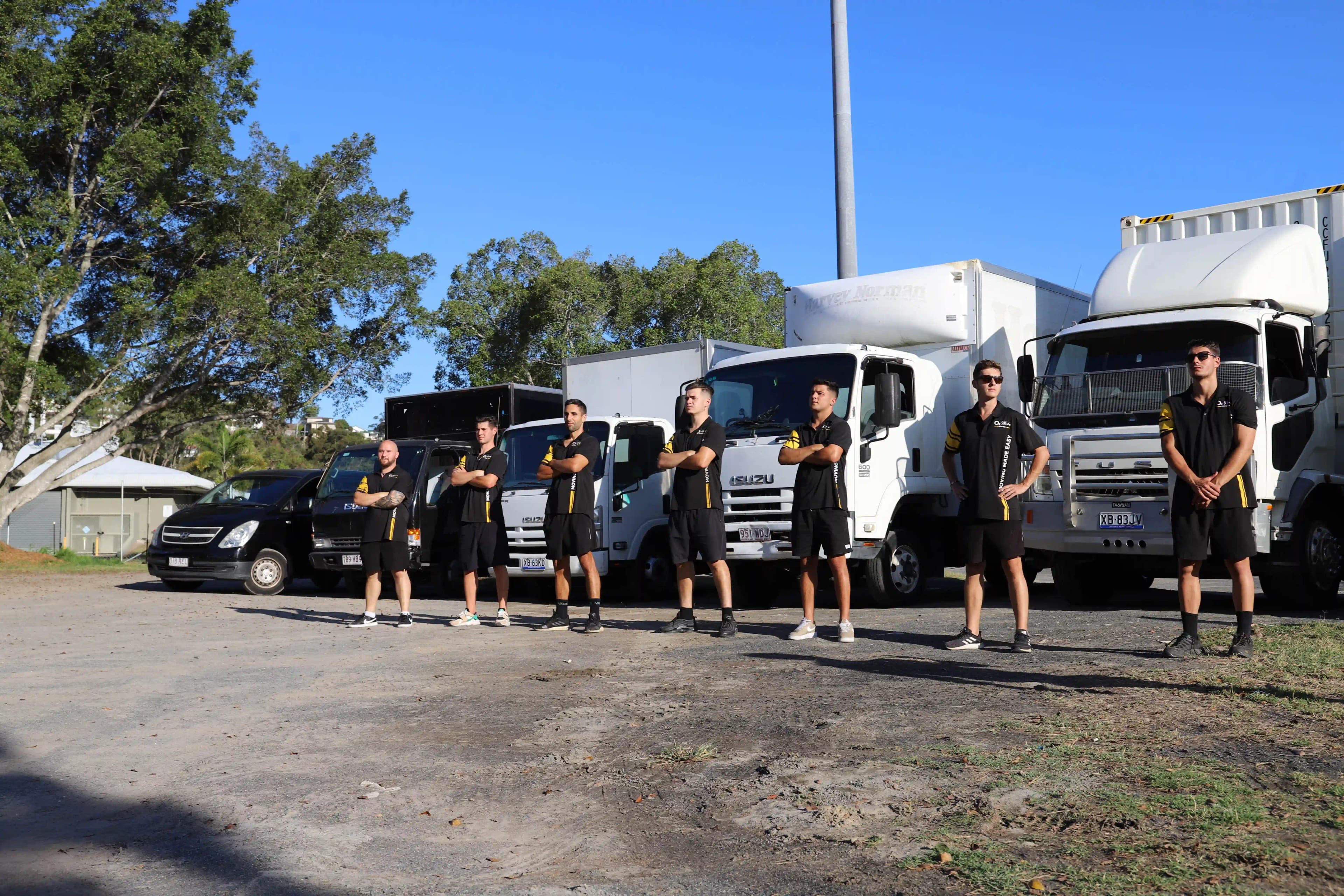 Removalists standing in front of trucks